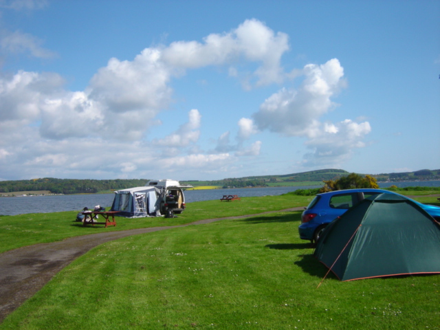 Image of tents next to a river