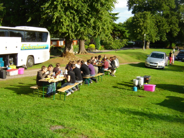 Image of people having a meal on the side of the road